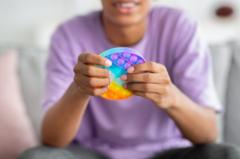 Young teen playing with fidget toy
